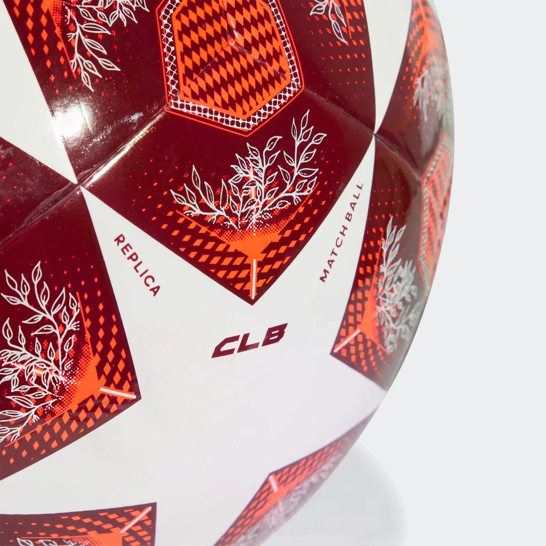 Close-up of a Ucl Club Size 4 soccer ball in red and white, detailed with geometric and leaf patterns, and 'REPLICA'