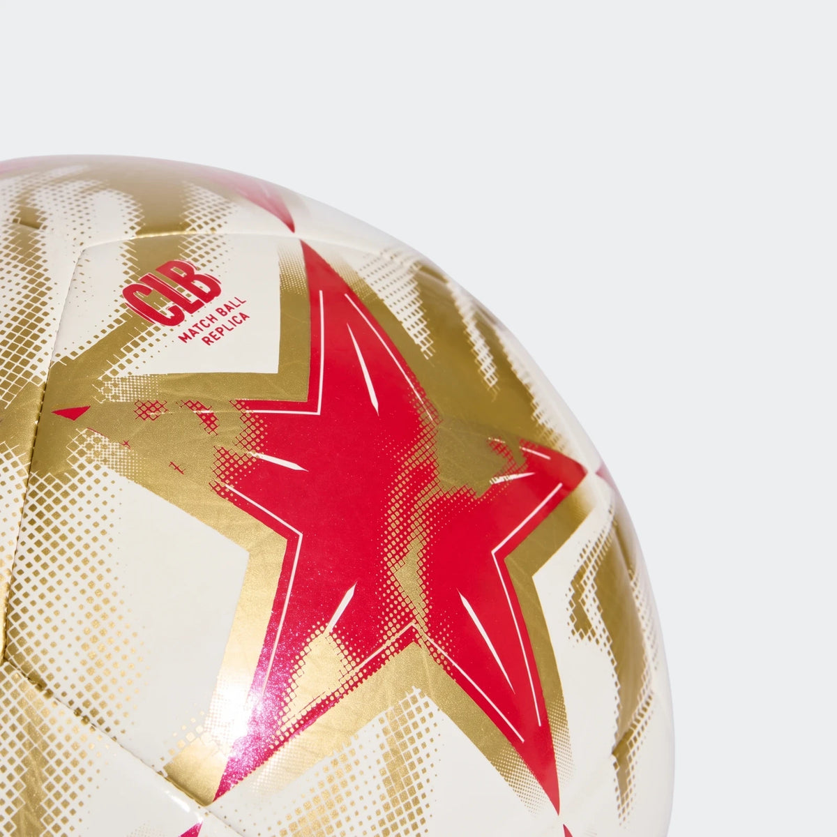 Close-up of the Uefa Champions League 26/27 Club Ball replica, featuring white, gold, and red star patterns.