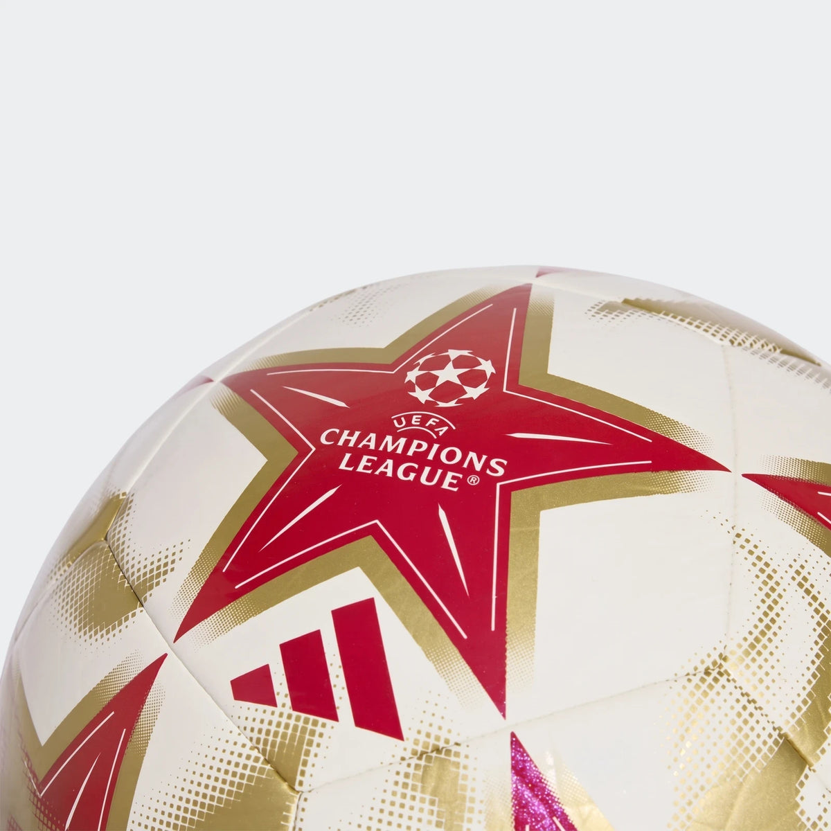 Close-up of a white, gold, and red Adidas Uefa Champions League 26/27 Club Ball, featuring the UEFA logo and distinctive
