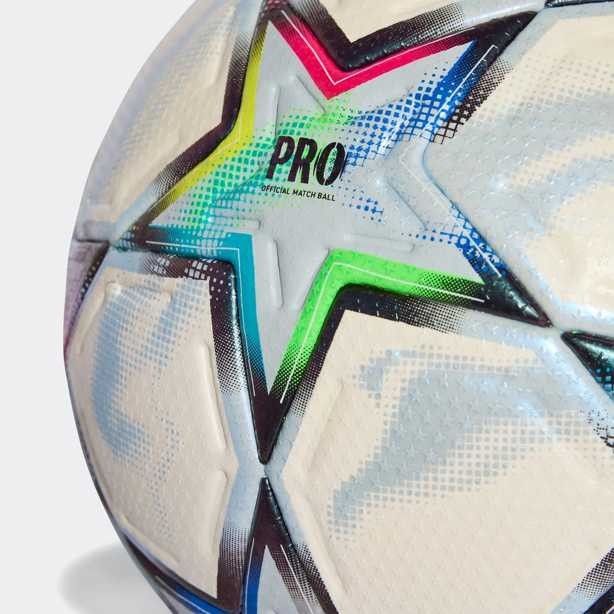 Close-up of a white Uefa Champions League 26/27 Pro Ball with vibrant multi-colored star patterns and 'PRO' branding.