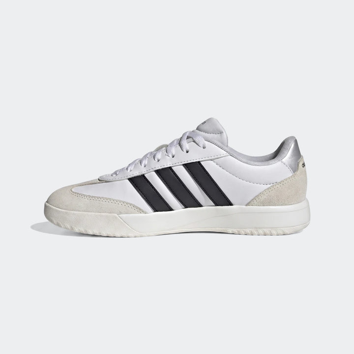 Vl Court Fc Ft white Adidas sneakers with black stripes and cream suede details, shown in a side view.