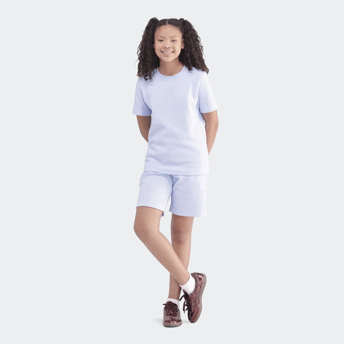 Waffle Set in light blue waffle-knit top and shorts, worn by a smiling child, showcasing comfortable textured fabric.