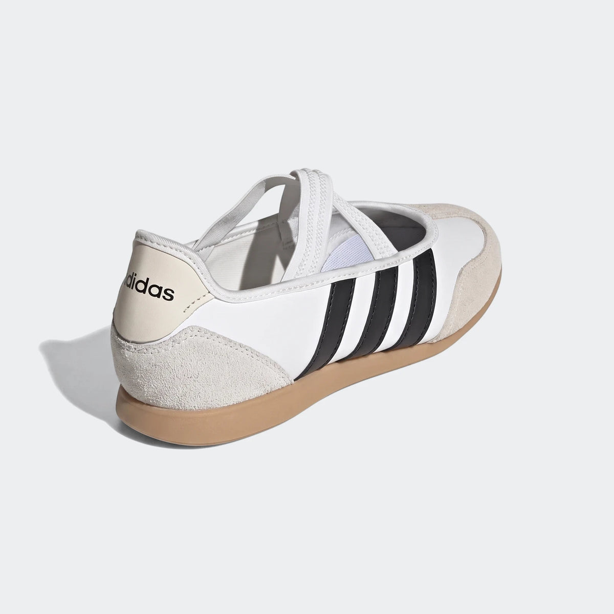 White Adidas Barreda Mary Jane shoes with black stripes and a beige heel tab, viewed from the rear quarter on a white