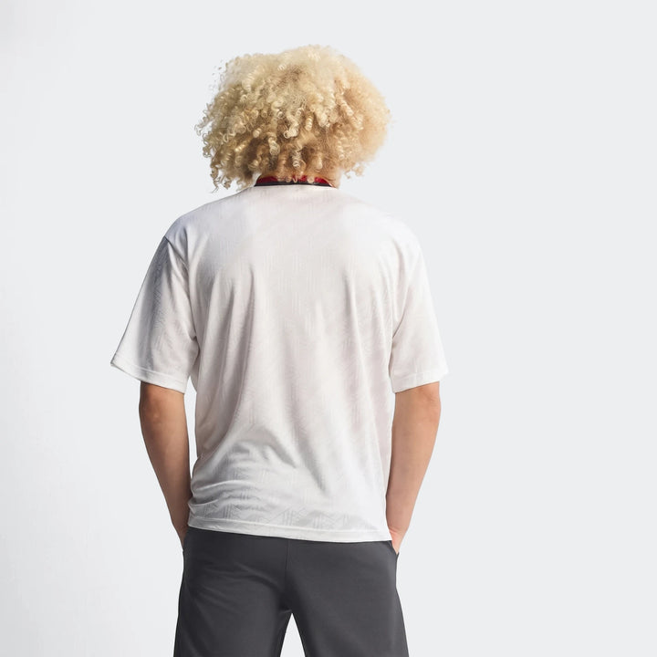White adidas Z.N.E. Track Top, shown from the back on a person with curly blonde hair, featuring subtle pattern.