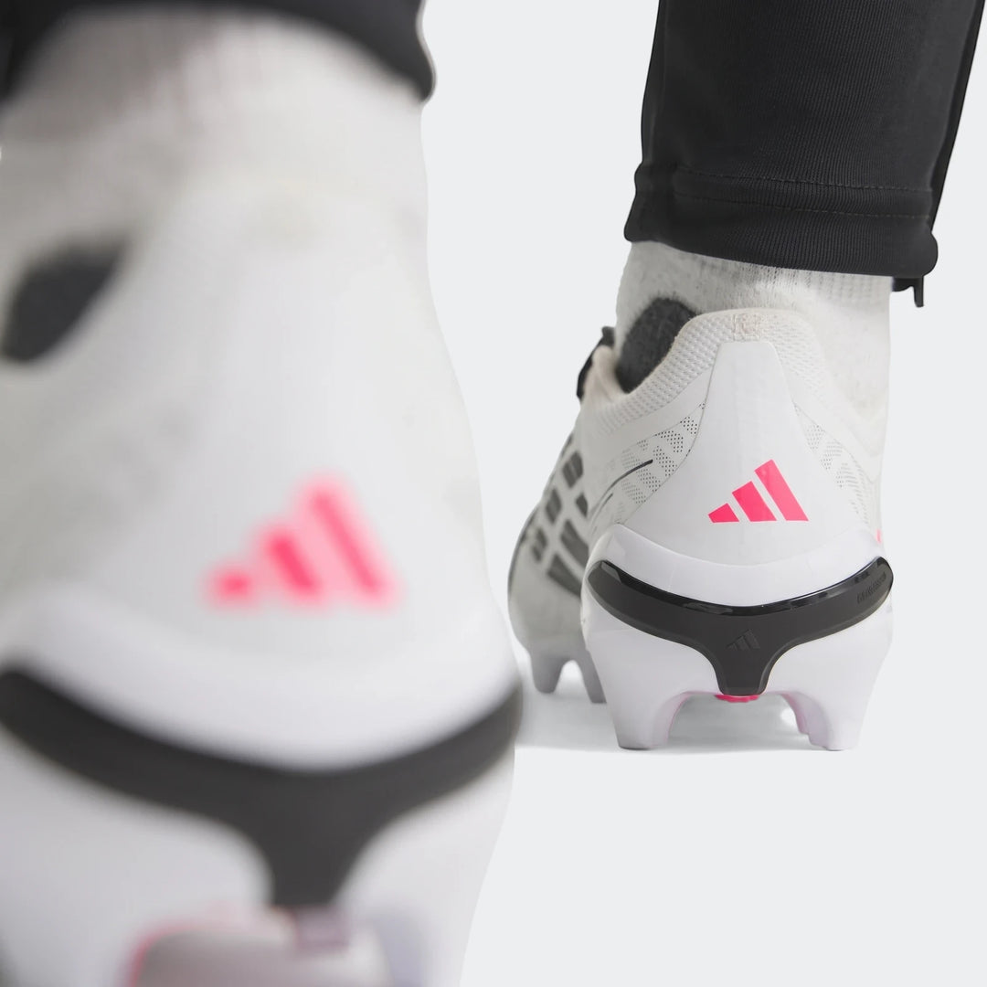 Rear view of white Predator League Fold-Over Tongue Firm Ground Football Boots with pink Adidas branding, worn on feet with