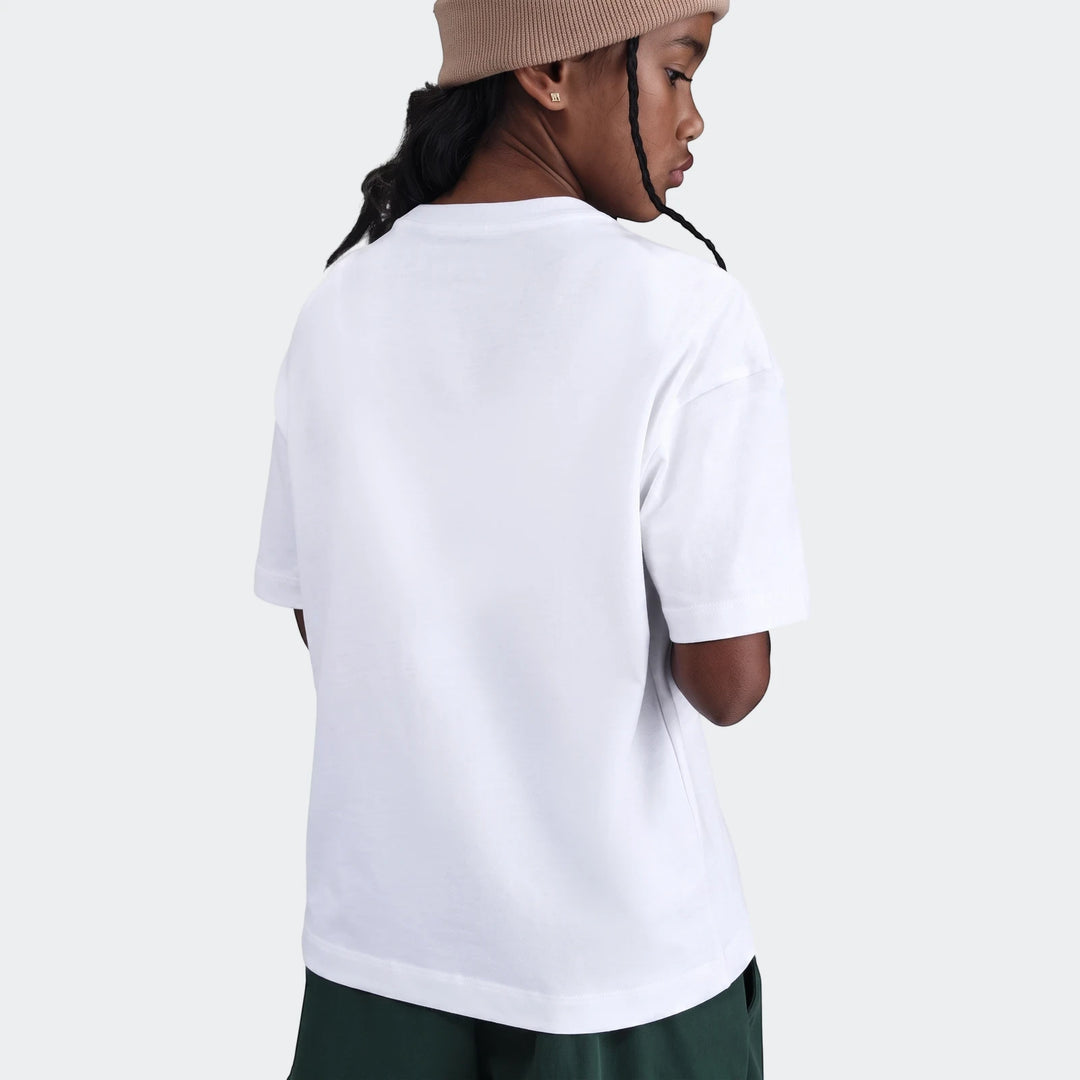 Back view of a model wearing a white short-sleeve t-shirt, brown beanie, and dark green shorts, styled for comfort.