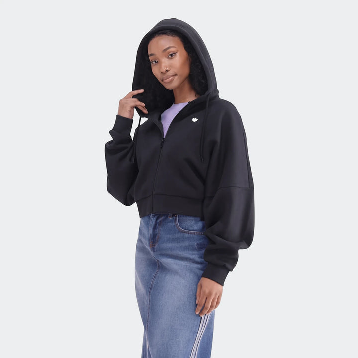 Woman wearing a black Essentials Full-Zip Hoodie and a blue denim midi skirt in a studio setting.