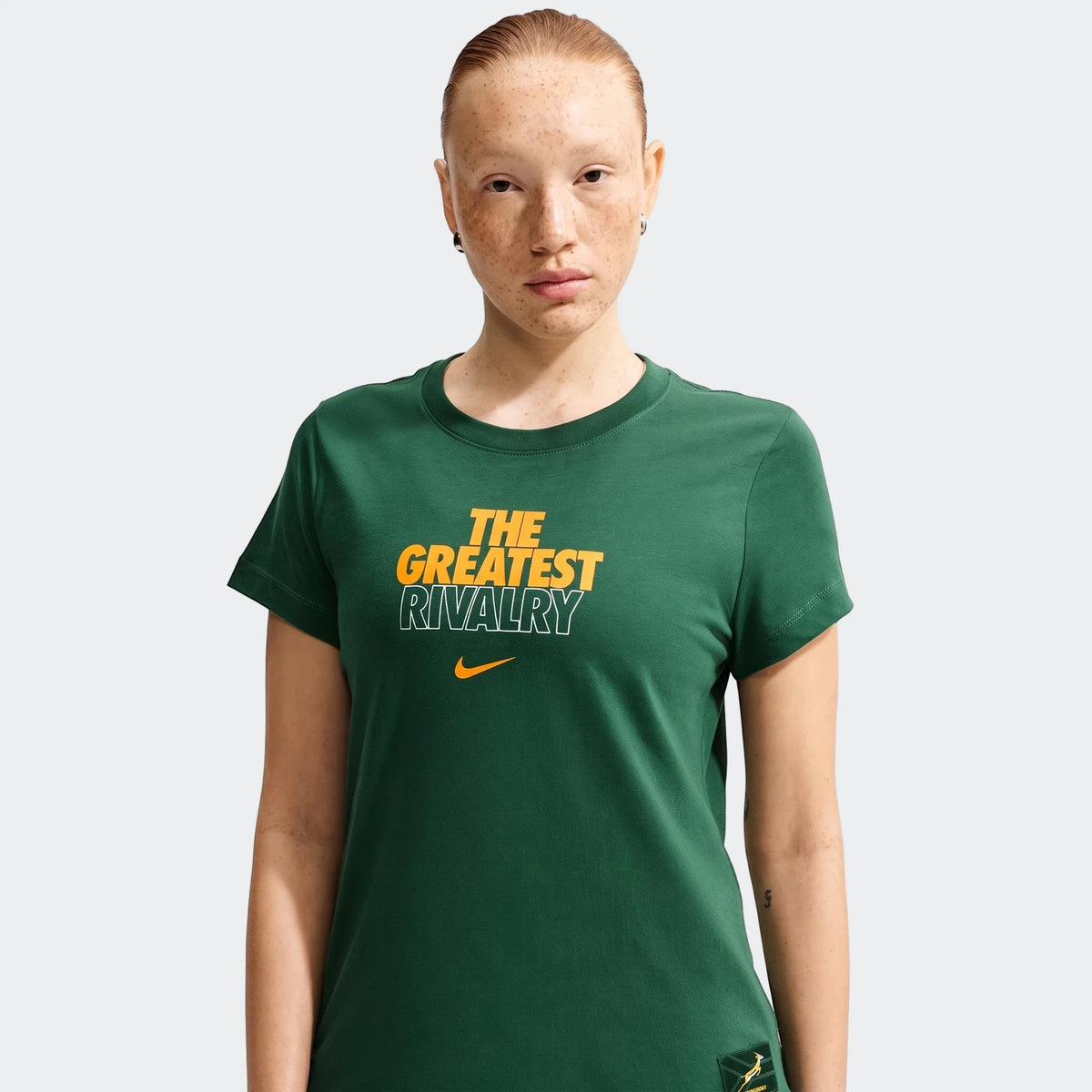 Woman wearing a dark green 2026 Nike Springboks Rugby's Greatest Rivalry Tour T-shirt, front view.