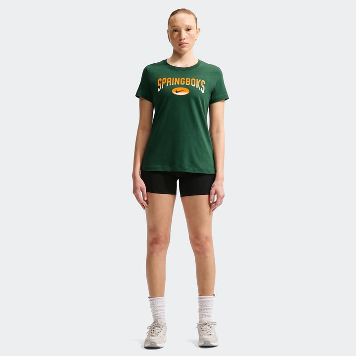 A full-body image of a woman wearing a dark green Nike South Africa Springboks Rugby T-Shirt with an orange logo, black