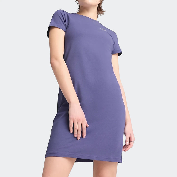 Woman wearing a short-sleeved purple Ess+ logo t-shirt dress. Casual style with a small white logo on the chest.