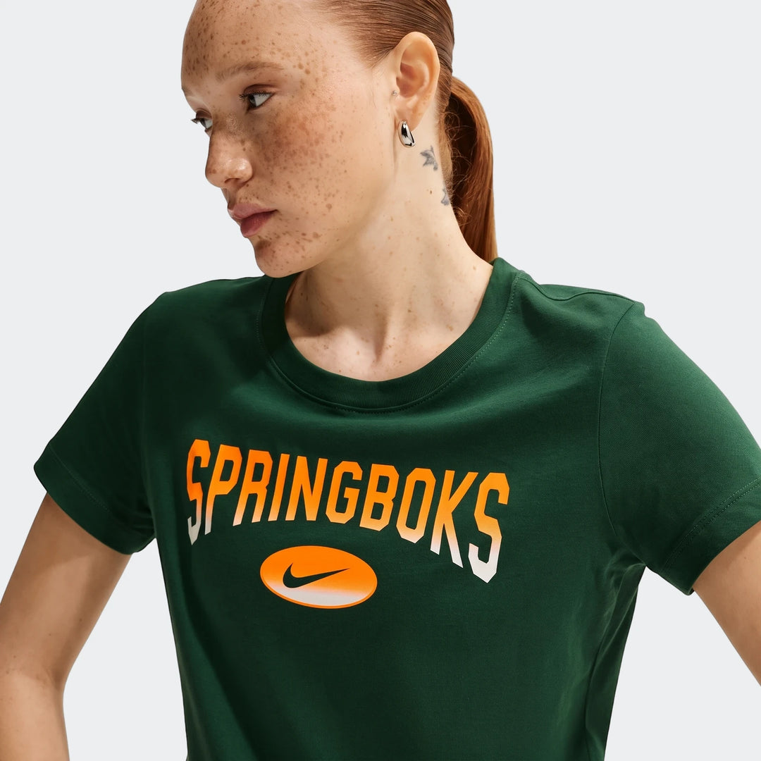 A woman models a dark green Nike South Africa Springboks Rugby T-shirt with an orange and white gradient logo and round neck.