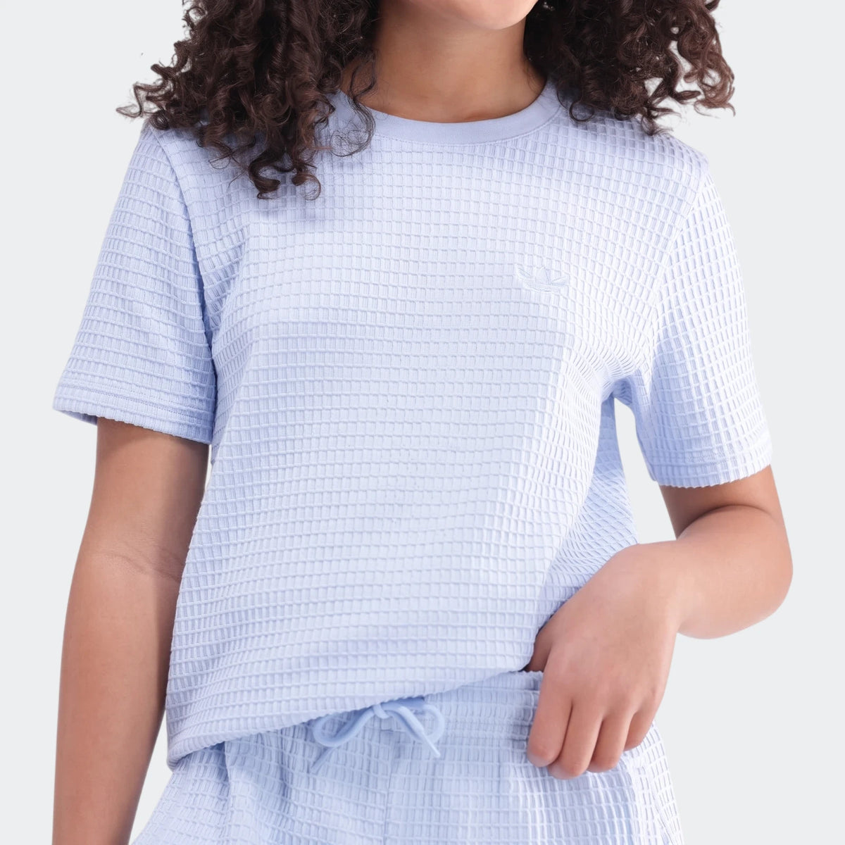 Light blue waffle knit short sleeve t-shirt and matching shorts set for women, shown worn from waist up.