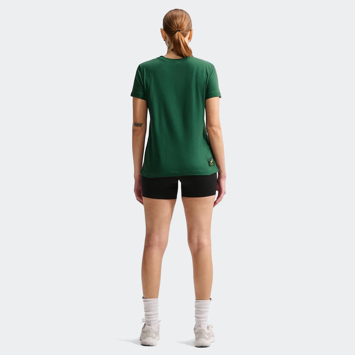 Back view of a woman wearing a dark green Nike South Africa Springboks Rugby T-Shirt and black shorts, standing.