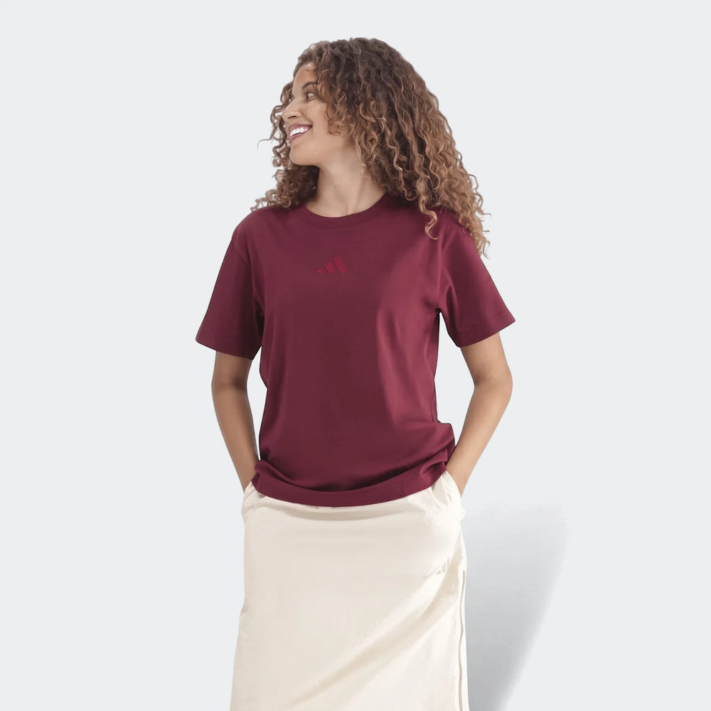 Young woman wearing a marl burgundy Slim Single Jersey T-Shirt and a cream midi skirt, looking right.