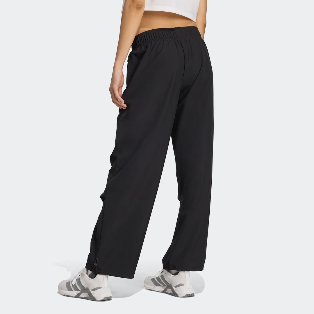 Black Workout Essentials Woven Training Joggers worn by a model from a back-side view, showing elastic waistband and hem