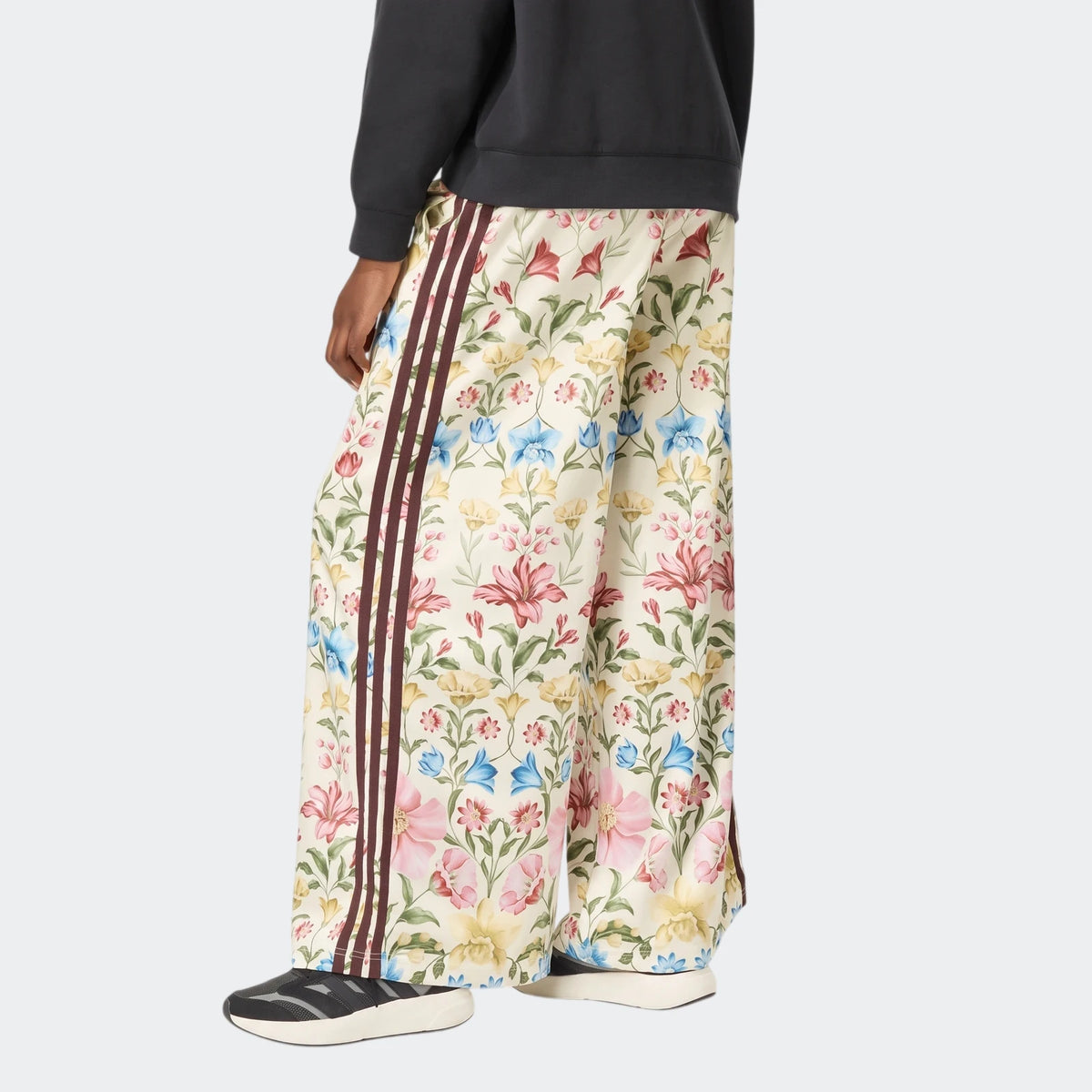 X Farm Rio Premium Joggers in a cream base with vibrant multi-color floral print, featuring brown side stripes and a