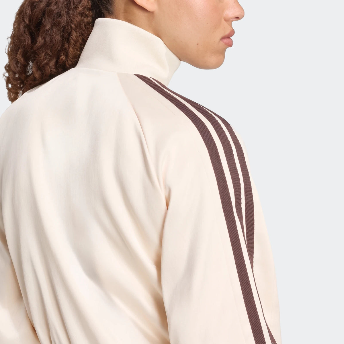 X Farm Rio Premium Tracktop in cream with brown stripes, seen from the back and side on a model.