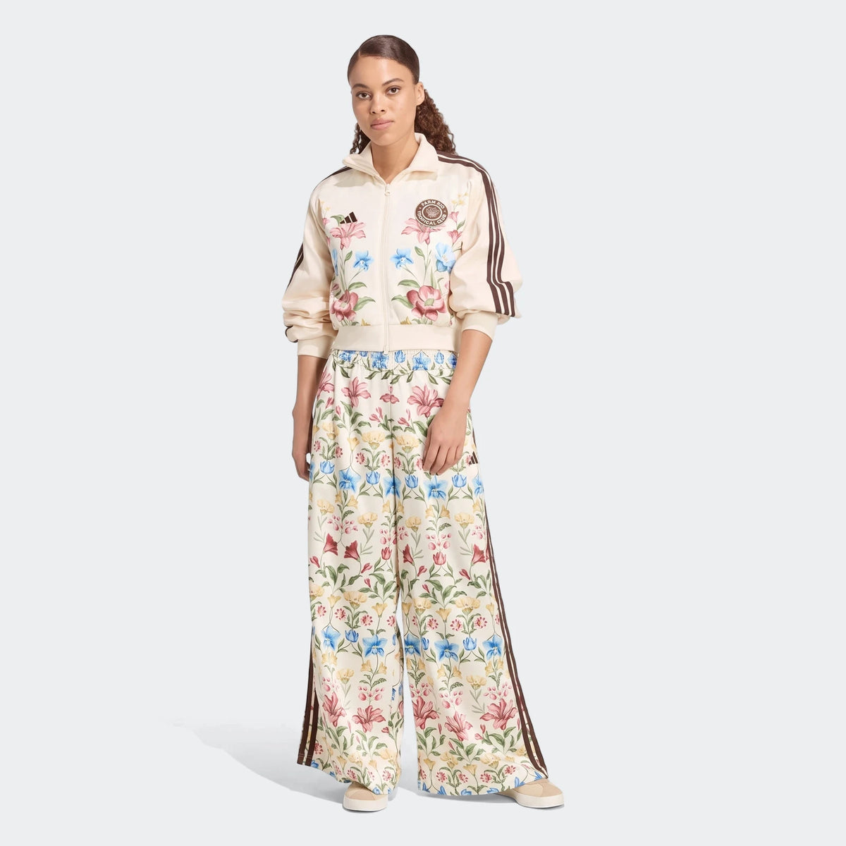 Women's X Farm Rio Premium Tracktop and matching wide-leg track pants in cream with a vibrant floral print, modeled
