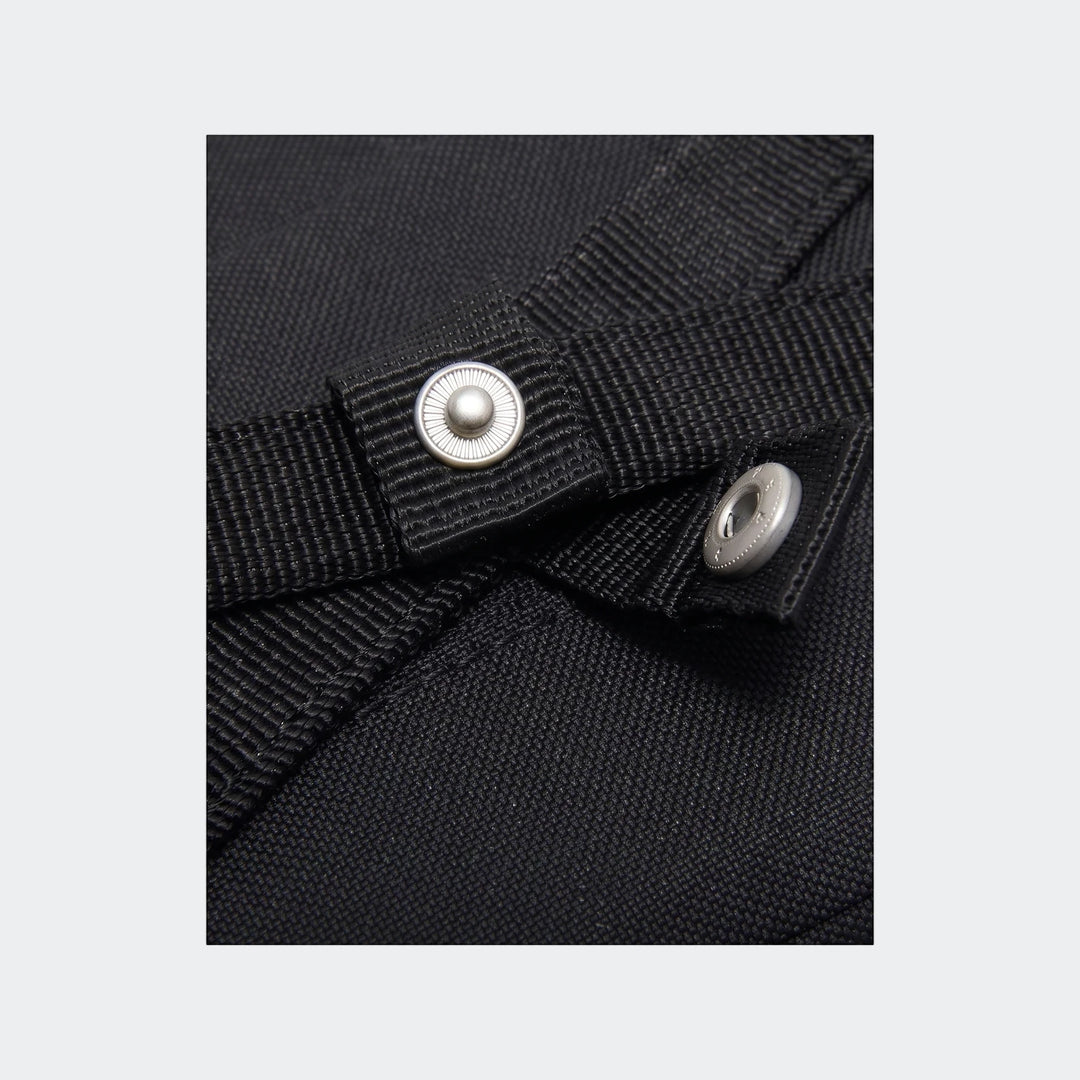 Close-up detail of a black Y Nk Gym Club Sp23 bag, showing the woven fabric and a silver snap button.