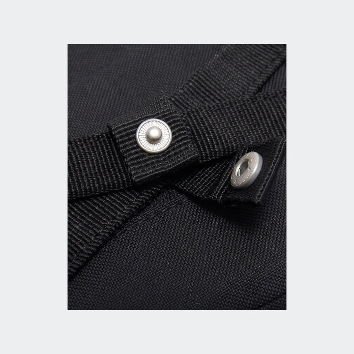 Close-up detail of a black Y Nk Gym Club Sp23 bag, showing the woven fabric and a silver snap button.