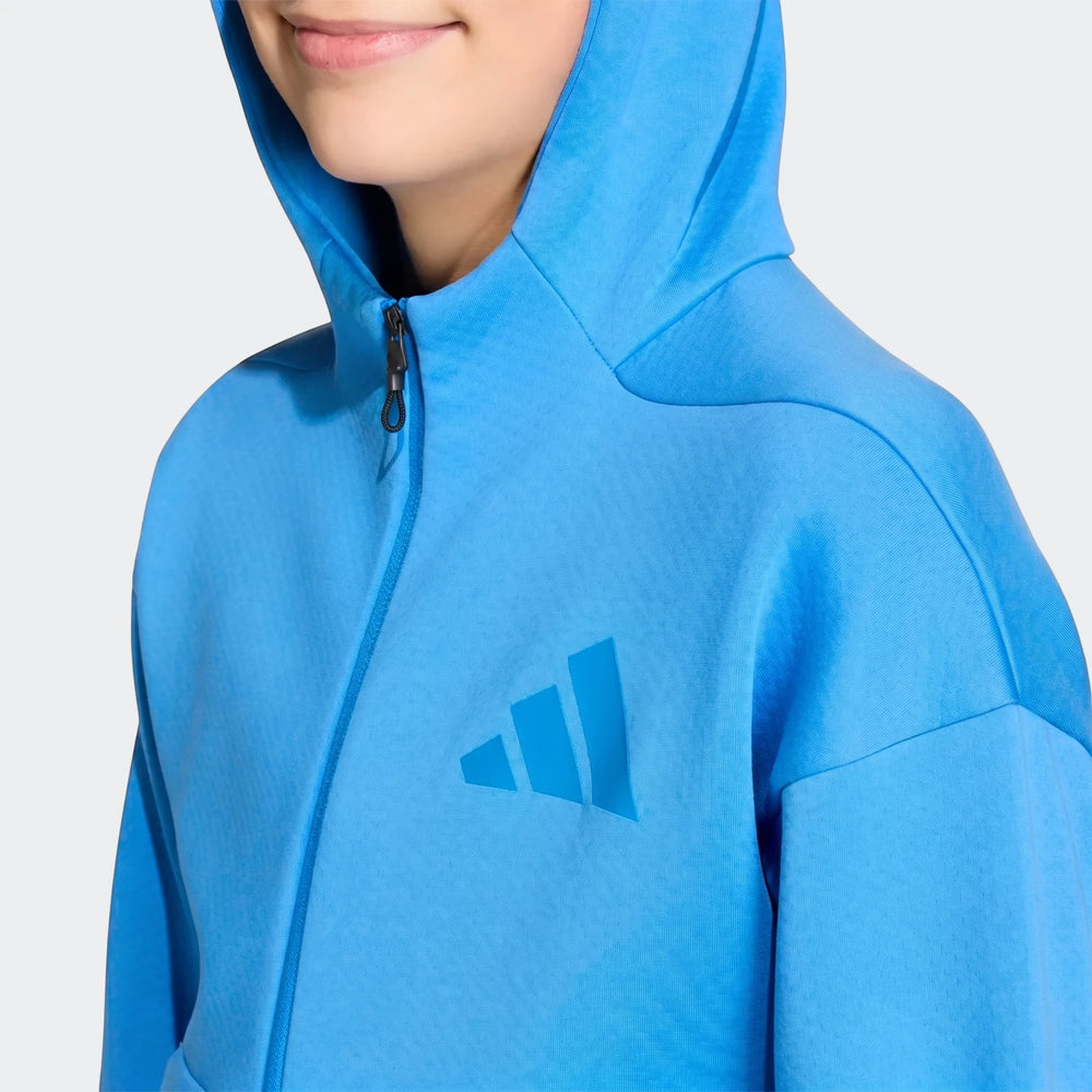 Youth Z.N.E. Full-Zip Hoodie in bright blue, worn by a child, featuring a visible Adidas logo and partial black zipper.