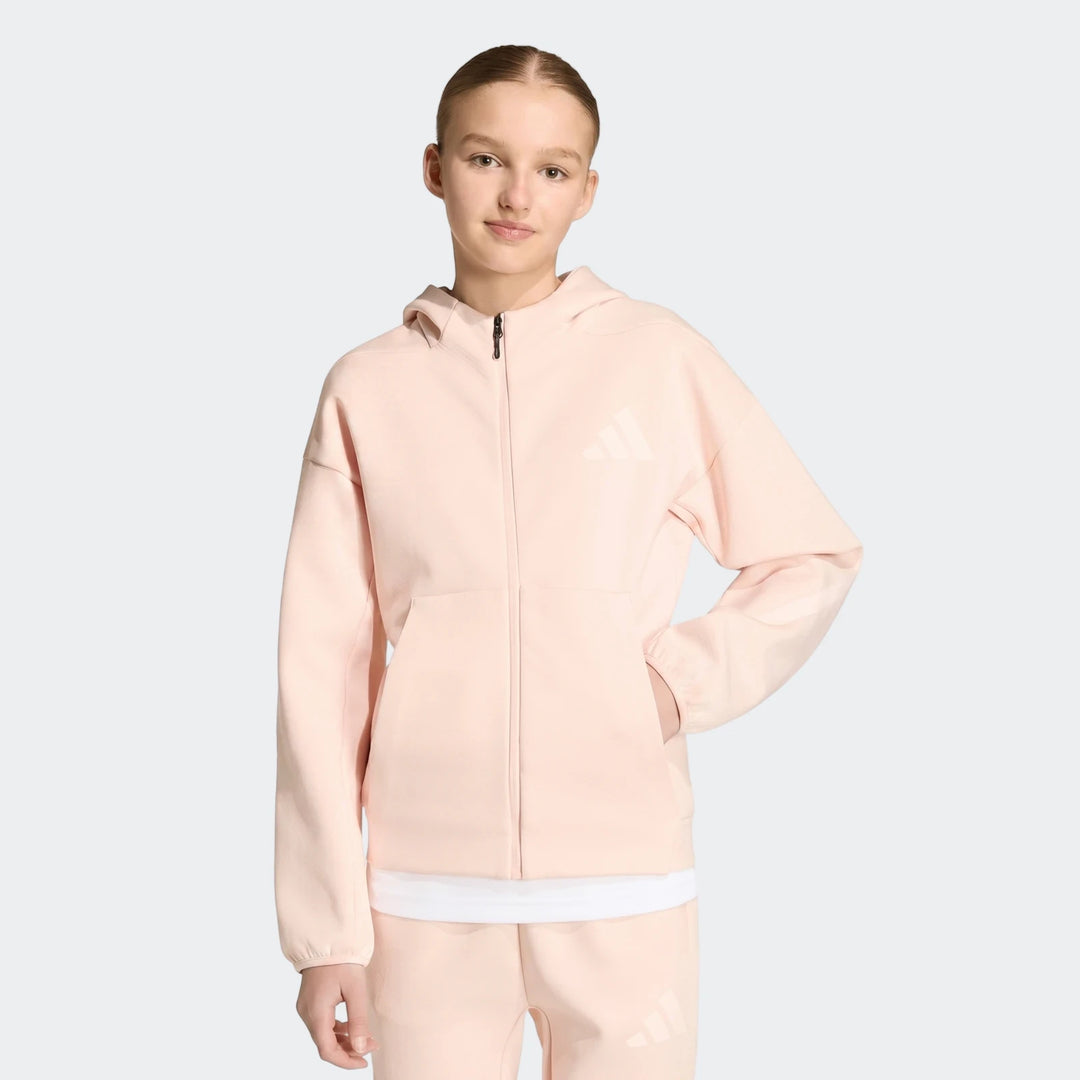 Youth Z.N.E. Full-Zip Hoodie in peach, worn by a young girl standing frontally, with hands in pockets.