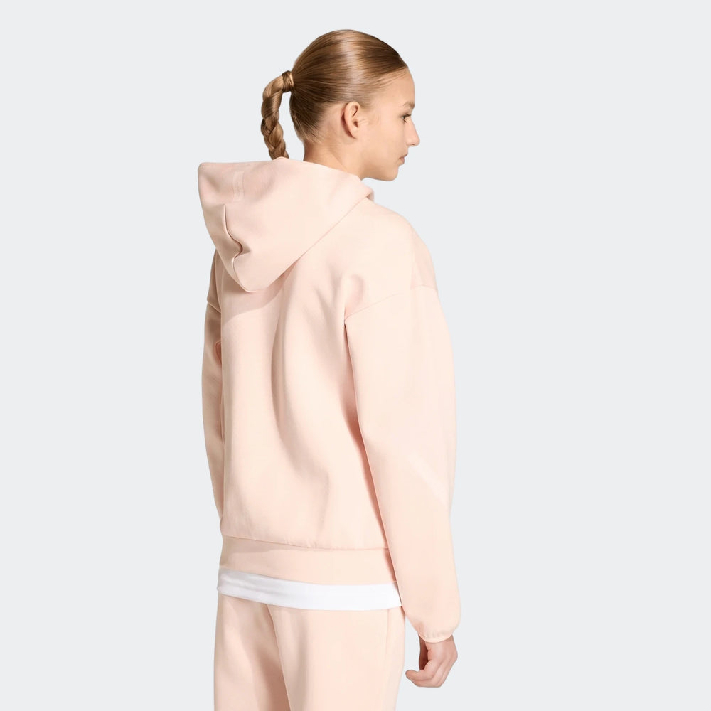 Light pink Youth Z.N.E. Full-Zip Hoodie on a young girl, photographed from the back-left side, showcasing the design.