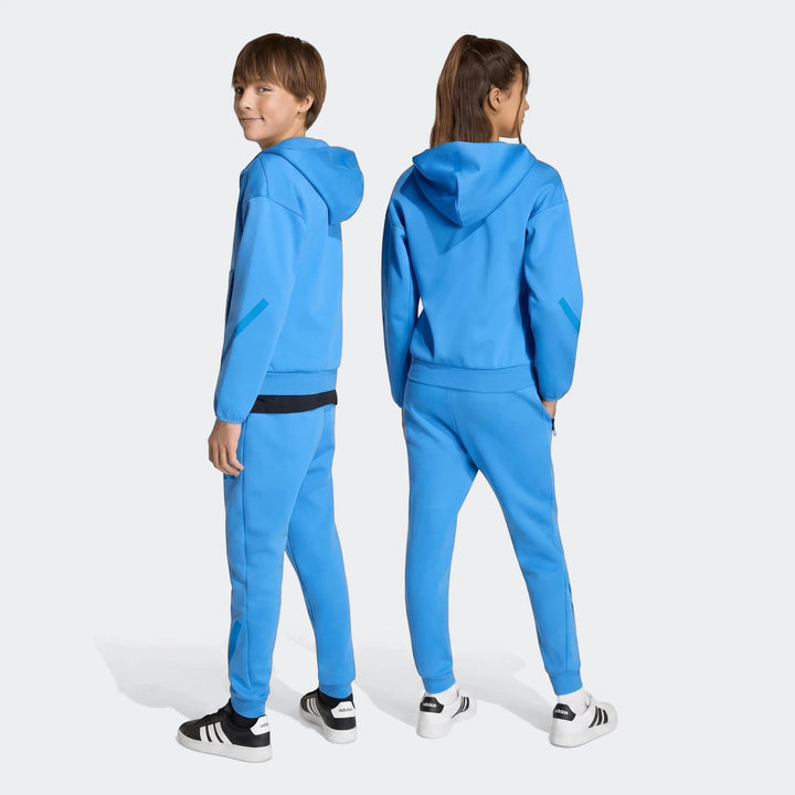 Two youth models wear blue Youth Z.N.E. Track Pants and matching hoodies, showcasing the front and back views on a simple