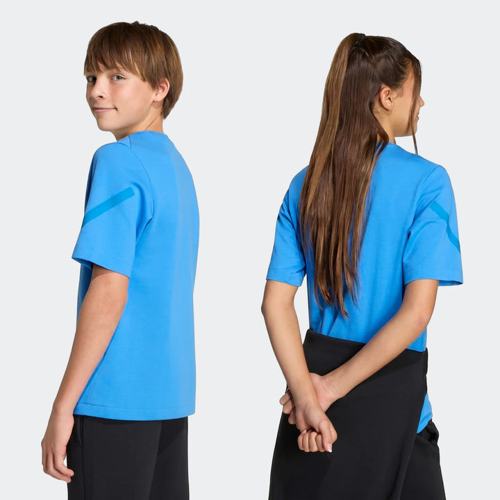 A young boy and girl model the blue Youth Z.N.E. short-sleeve t-shirt from different angles in a studio.