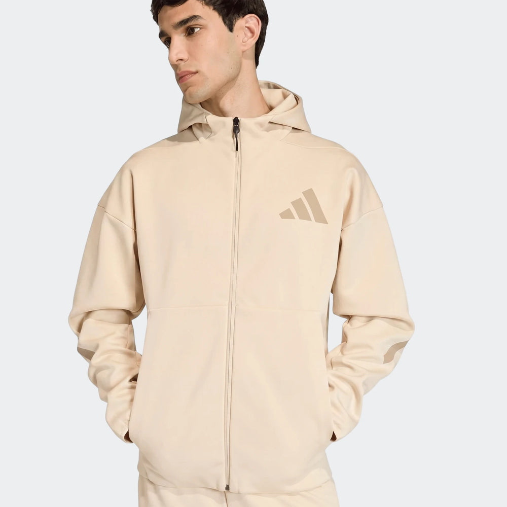 Z.N.E. Full-Zip Hoodie in light beige with hood and front zipper, shown from the front on a model.