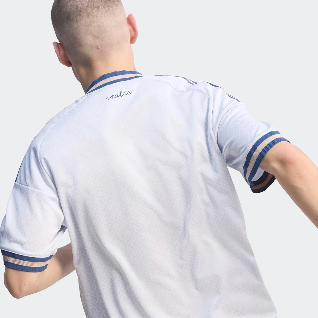 Back view of Z.N.E. Track Top in white with blue ribbed collar and sleeve cuffs, short-sleeve sporty fit.