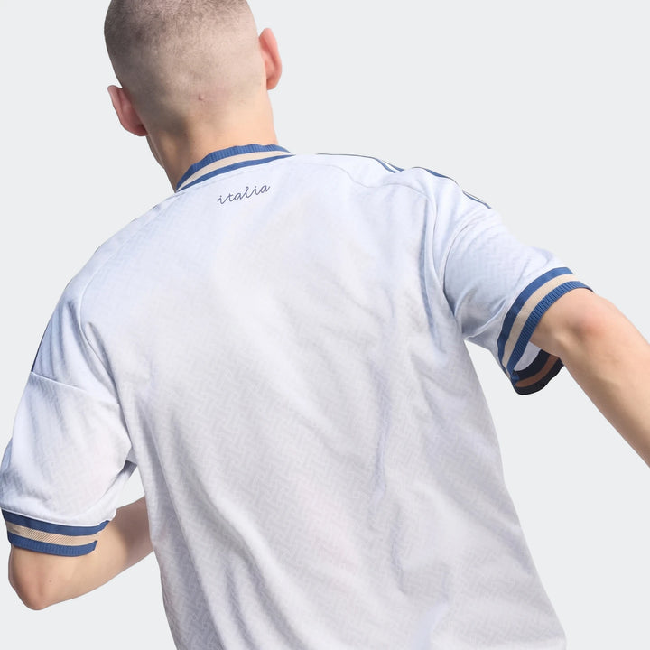 Back view of Z.N.E. Track Top in white with blue ribbed collar and sleeve cuffs, short-sleeve sporty fit.